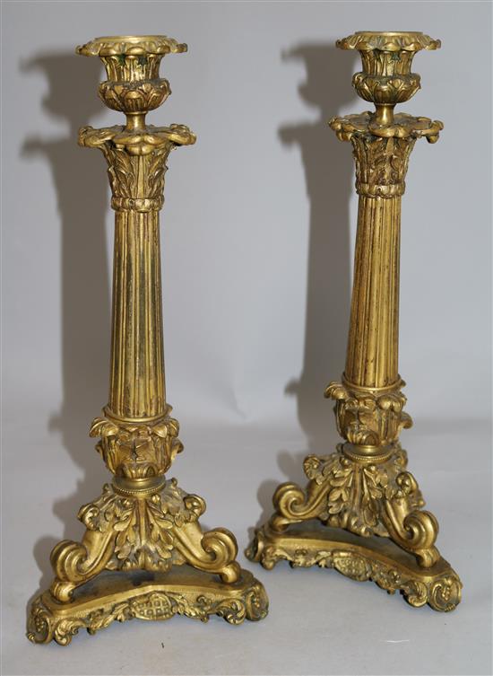A pair of William IV ormolu candlesticks, 13.5in.